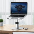 Aluminium car laptop stand in silver, showing adjustable height and rotating base with non-slip silicone pads.