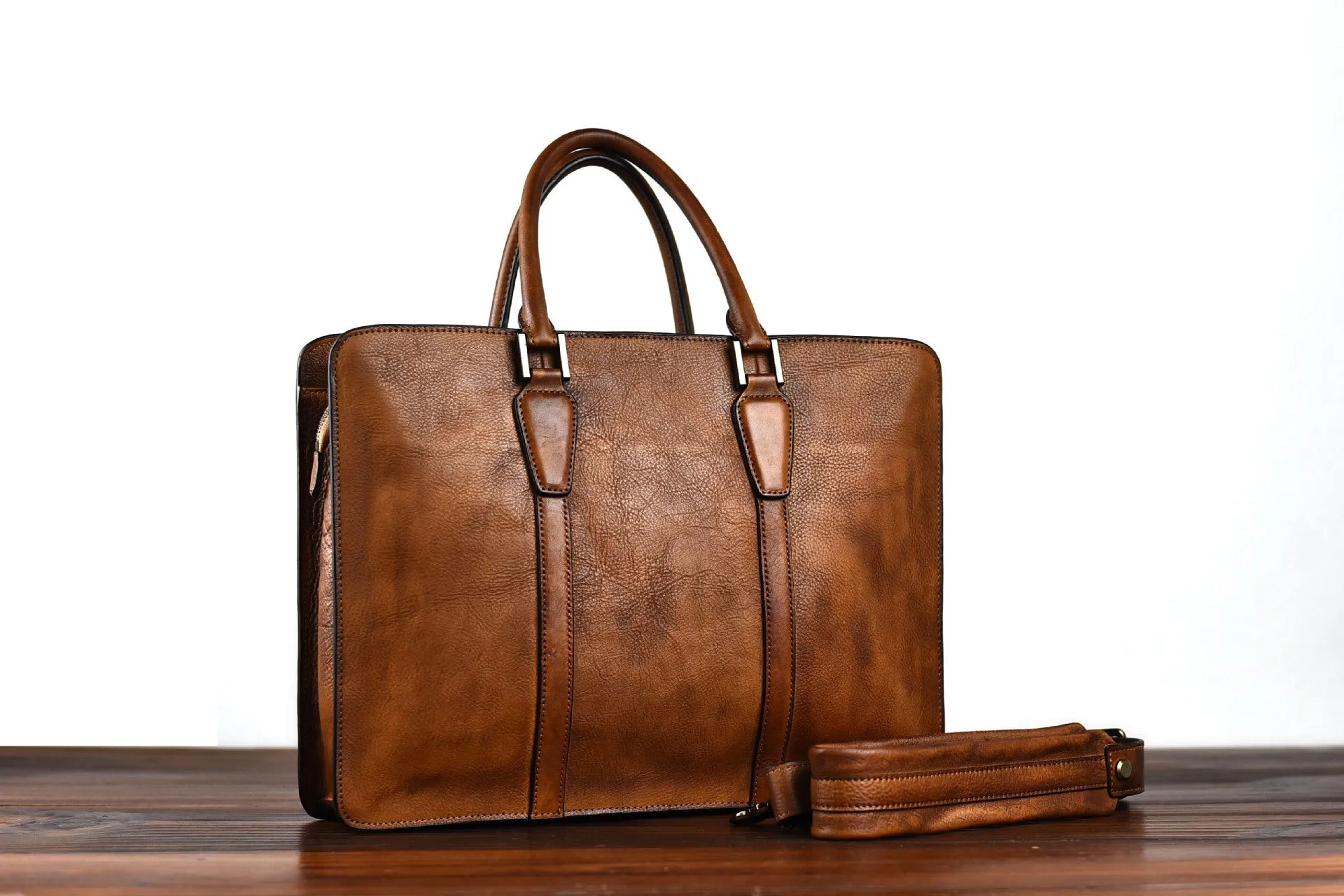 Men's brown leather business handbag with horizontal square shape and zipper opening