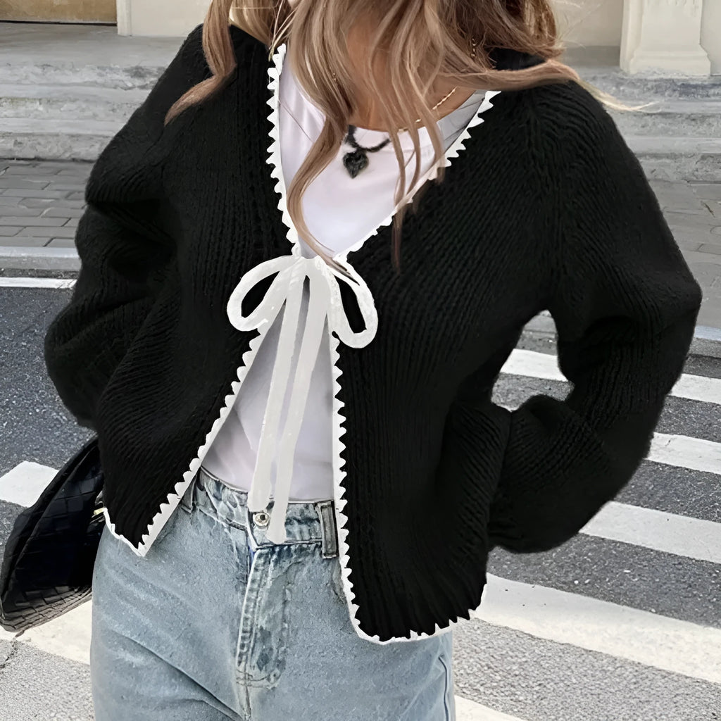 Grey lace-up sweater cardigan with long sleeves, a front crocheted flower, and a loose fit.