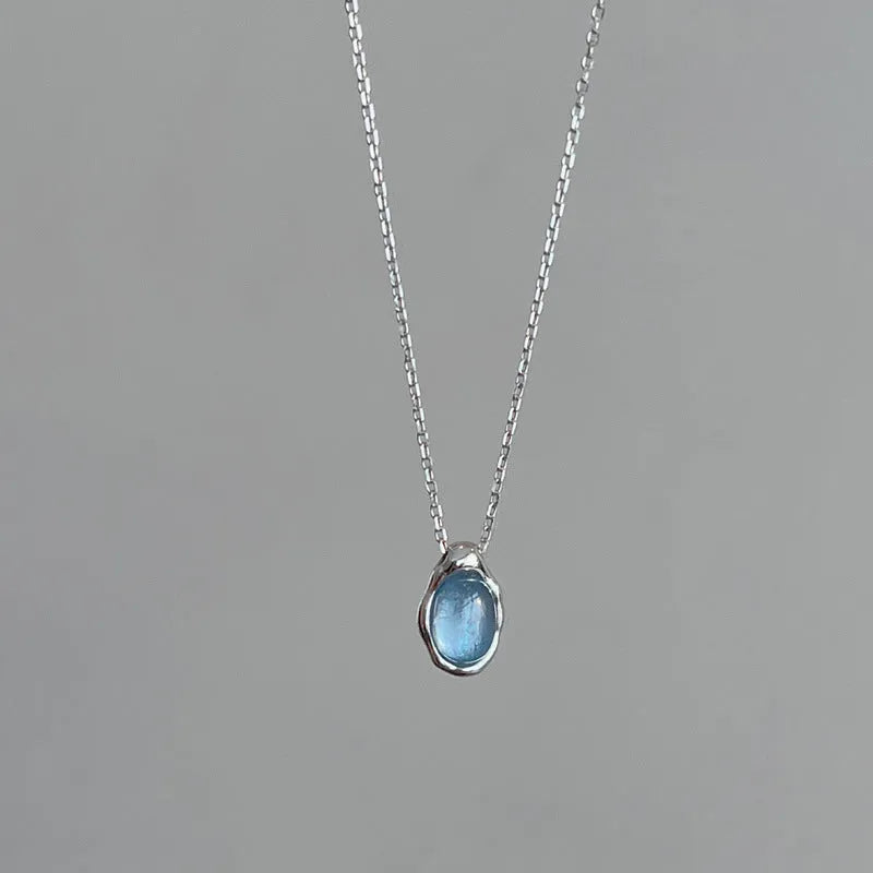 Women's navy blue geometric water drop necklace on adjustable cross chain