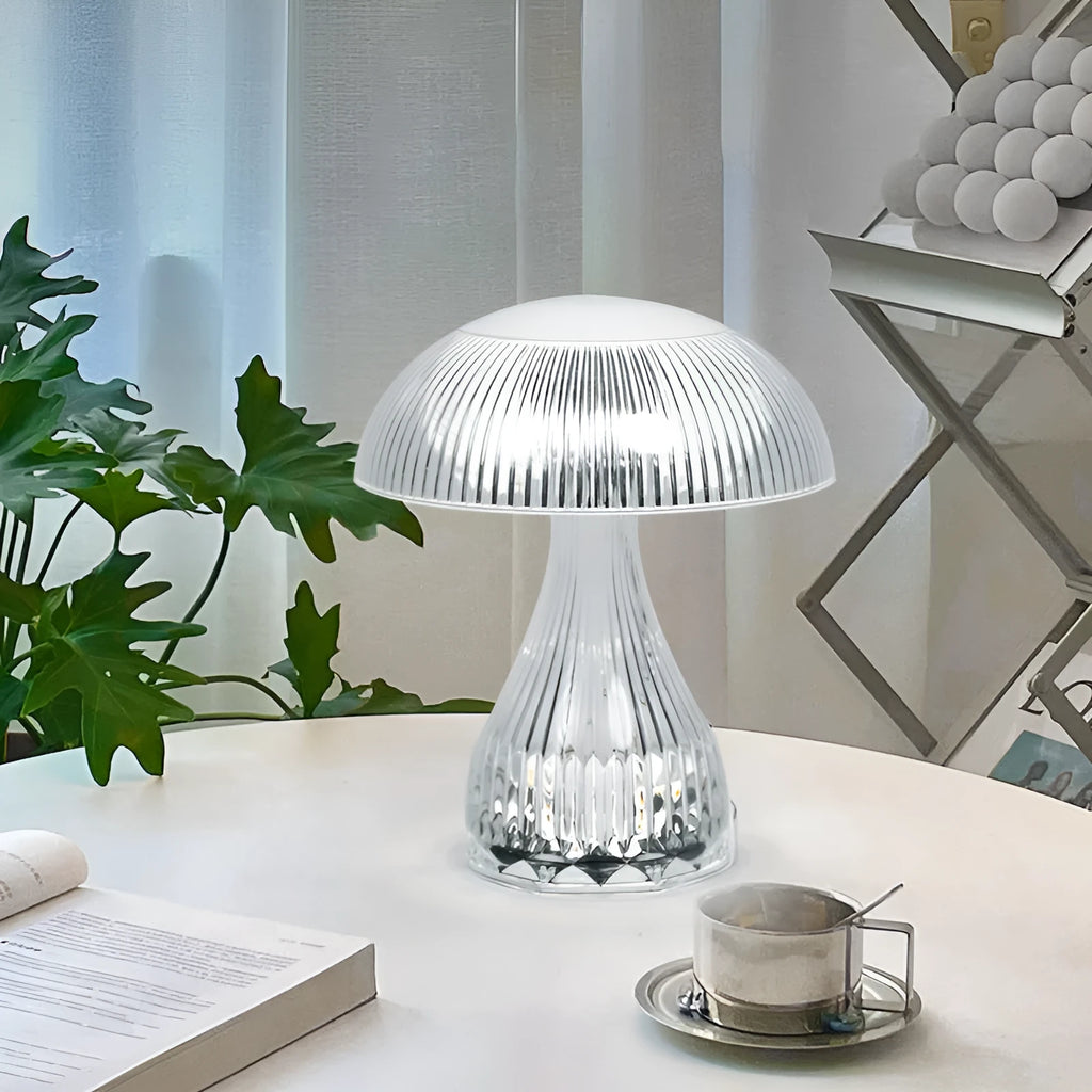 White rechargeable touch control bedside lamp with acrylic shade on a table.