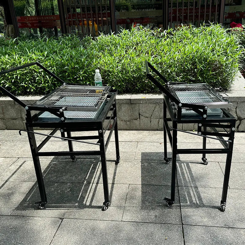 Large foldable L-size charcoal BBQ stove with grill, shown in a garden setting.