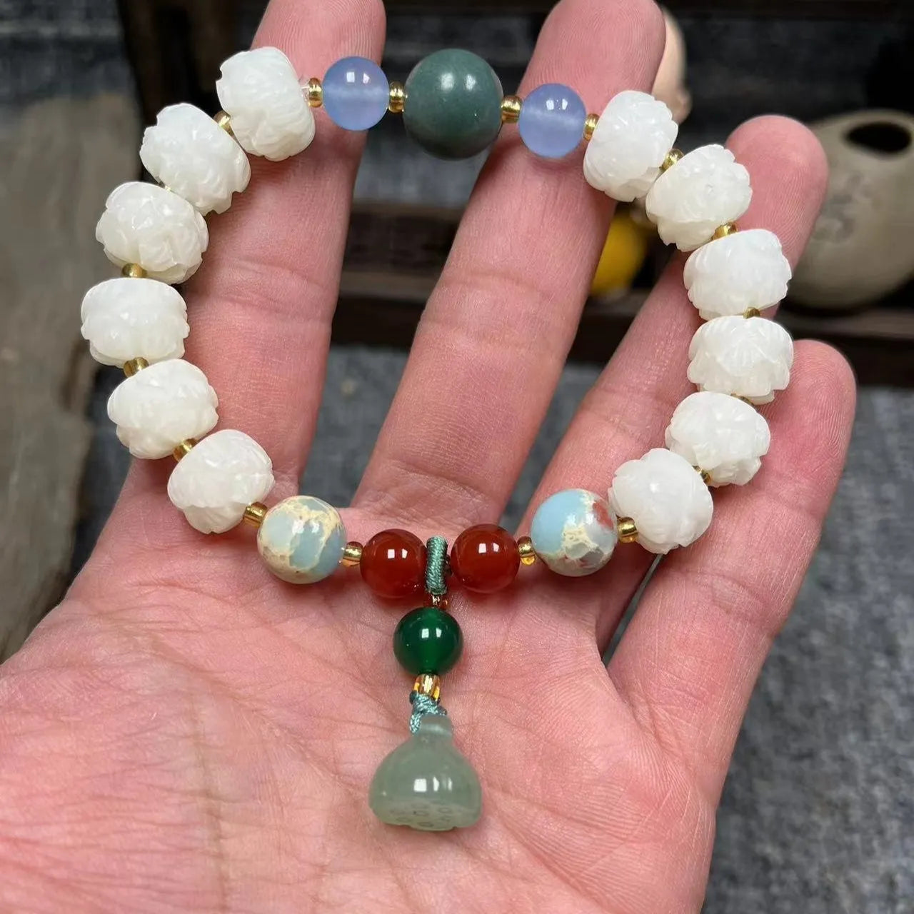 Carved pumpkin lotus bodhi root bracelet with white jade segments and golden silk jade treasures