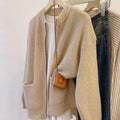Beige soft viscose knit cardigan with long sleeves shown on a hanger.