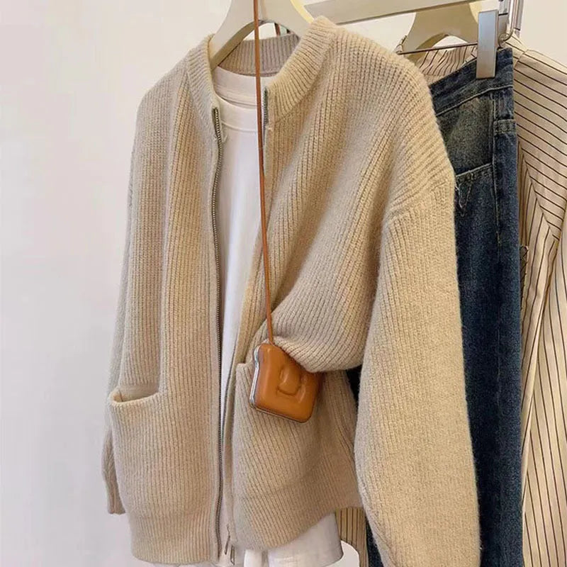 Beige soft viscose knit cardigan with long sleeves shown on a hanger.