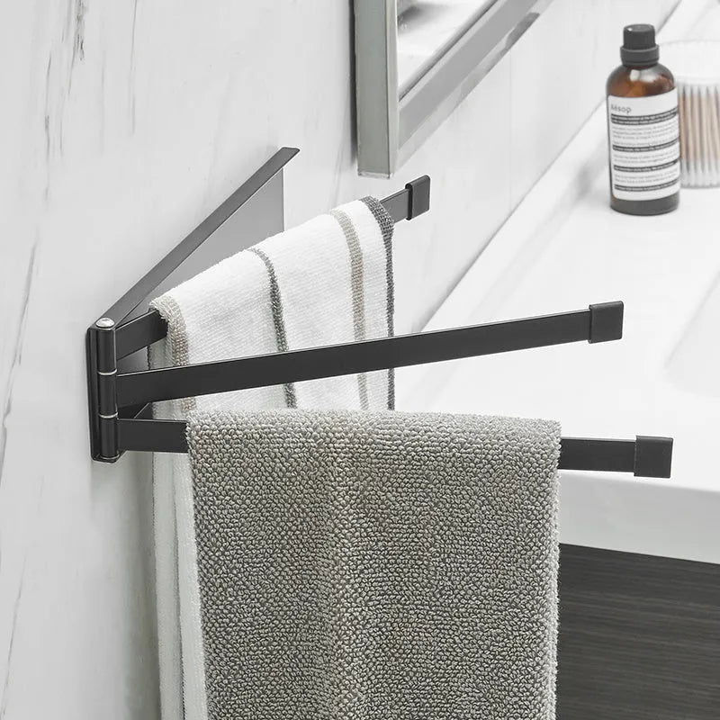 Nordic-style folding towel rack in black or white with adhesive mounting system