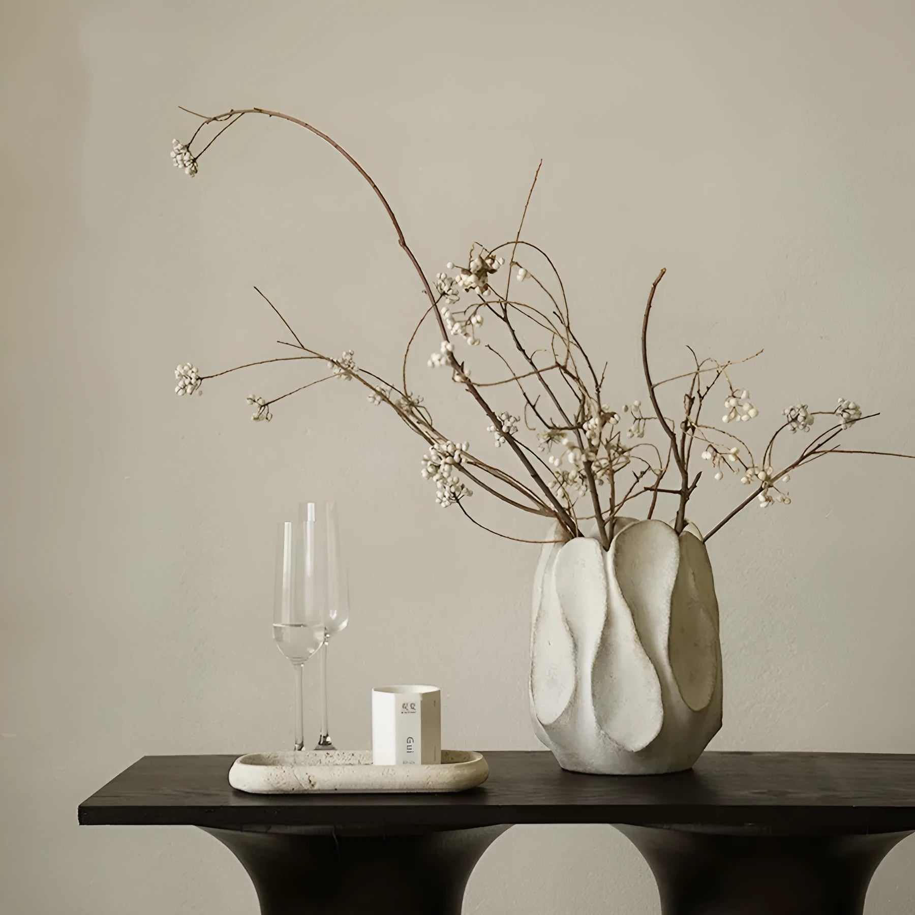 Handmade irregular ceramic vase in magnesium clay on a wooden surface.