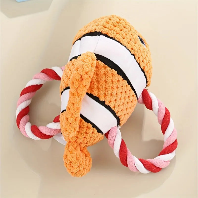 Green turtle-shaped plush dog chew toy with a knotted rope visible inside, on a white background.
