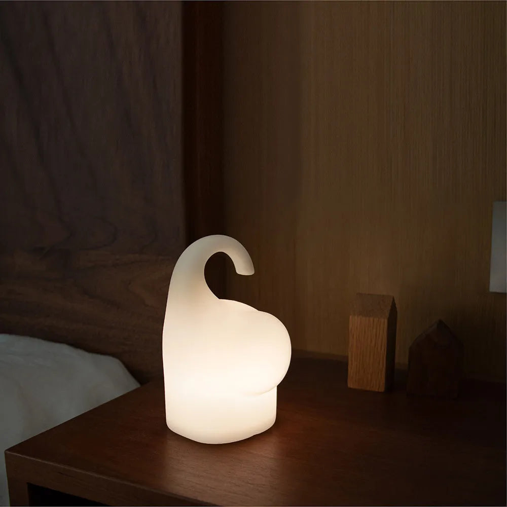 DOMI Elephant style LED night light with warm white glow on a bedside table.