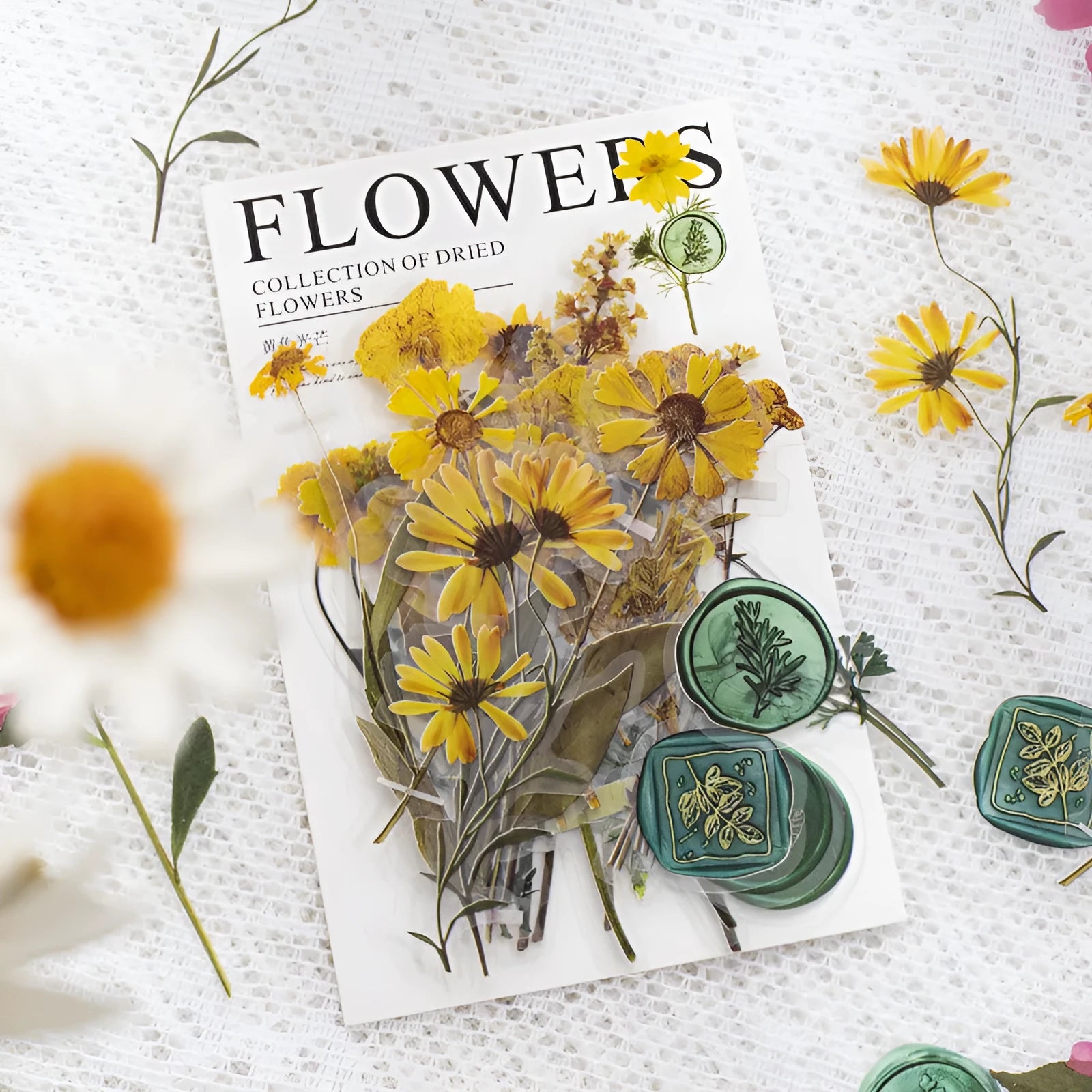 Package of 40 square dried flowers art sticker sheets in eight colour themes on a PET material base.