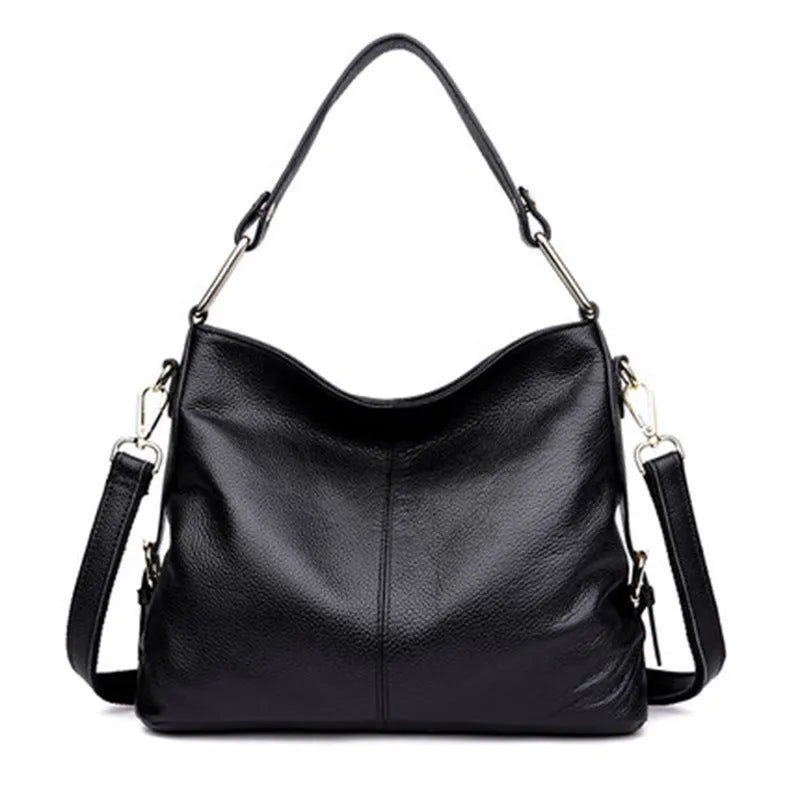 Square vertical genuine leather crossbody bag with multiple internal zipper compartments.