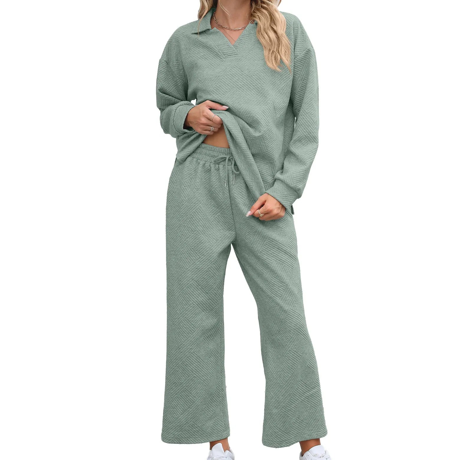 Women's black geometric pattern knitted suit set with long sleeve top and elastic waist cropped trousers.
