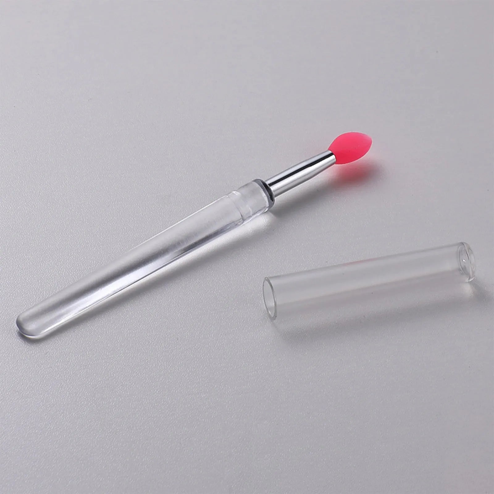 Set of silicone lip brushes with caps in various colours including blue, pink, and purple.