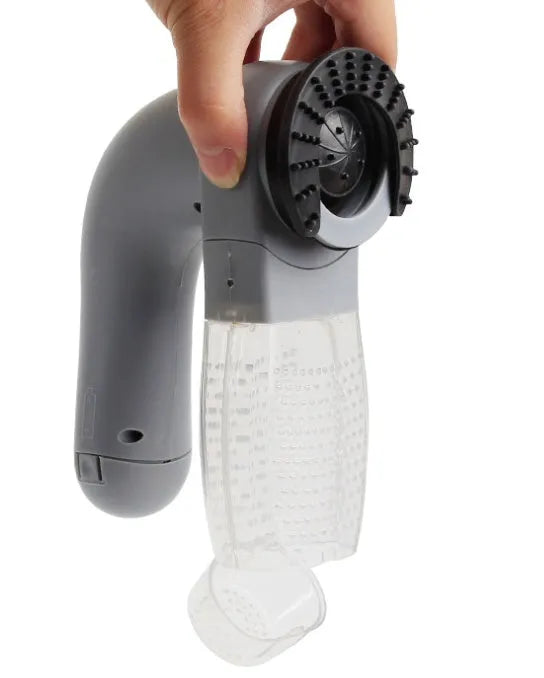 Gray portable electric pet hair remover with soft rubber head and collection canister.