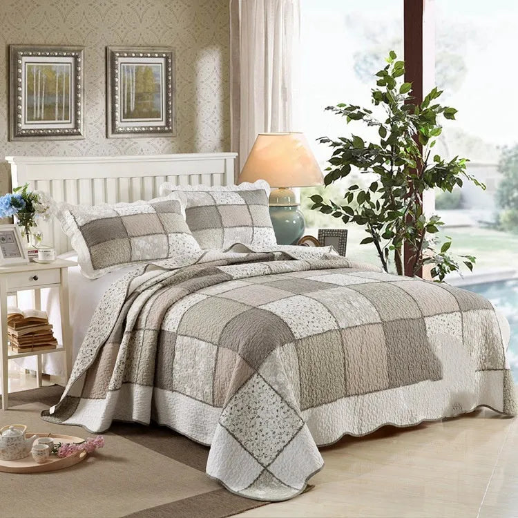 Pure cotton quilted bedspread three-piece set in washed fabric with pillowcases on a bed.