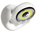 White Atomic Angel induction table lamp with compact ABS plastic body on a table.