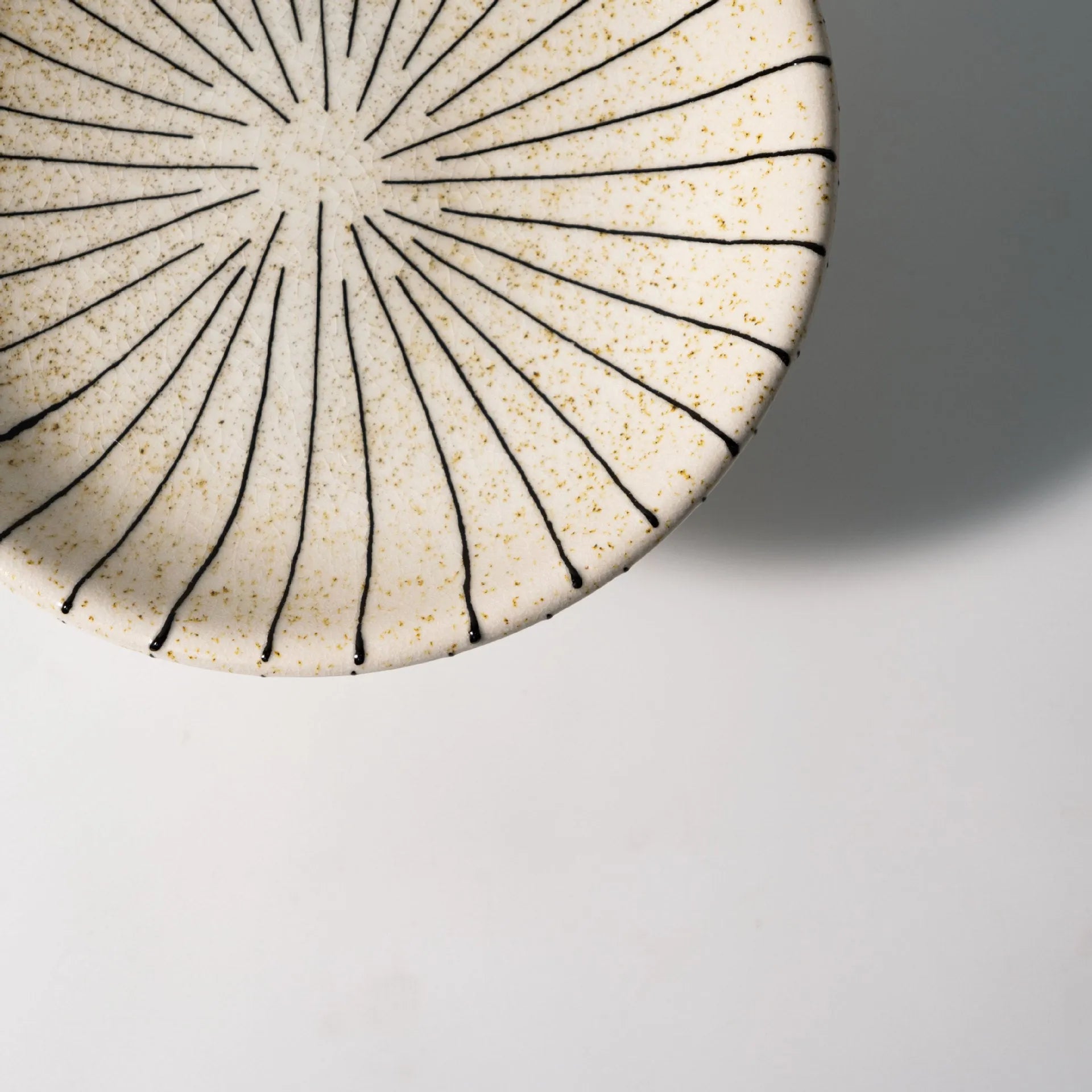 Black and white striped retro-style resin fruit or dessert plate on a table.
