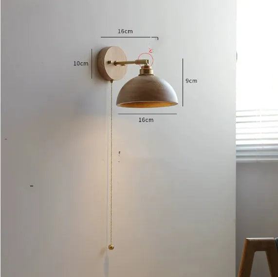 Nordic-style wooden wall lamp mounted beside a bed, shown in walnut brown and natural wood colour options.