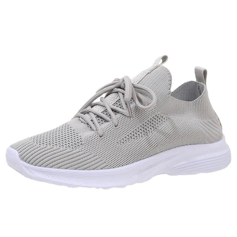 Women's cream running shoes with breathable mesh upper and flat rubber sole