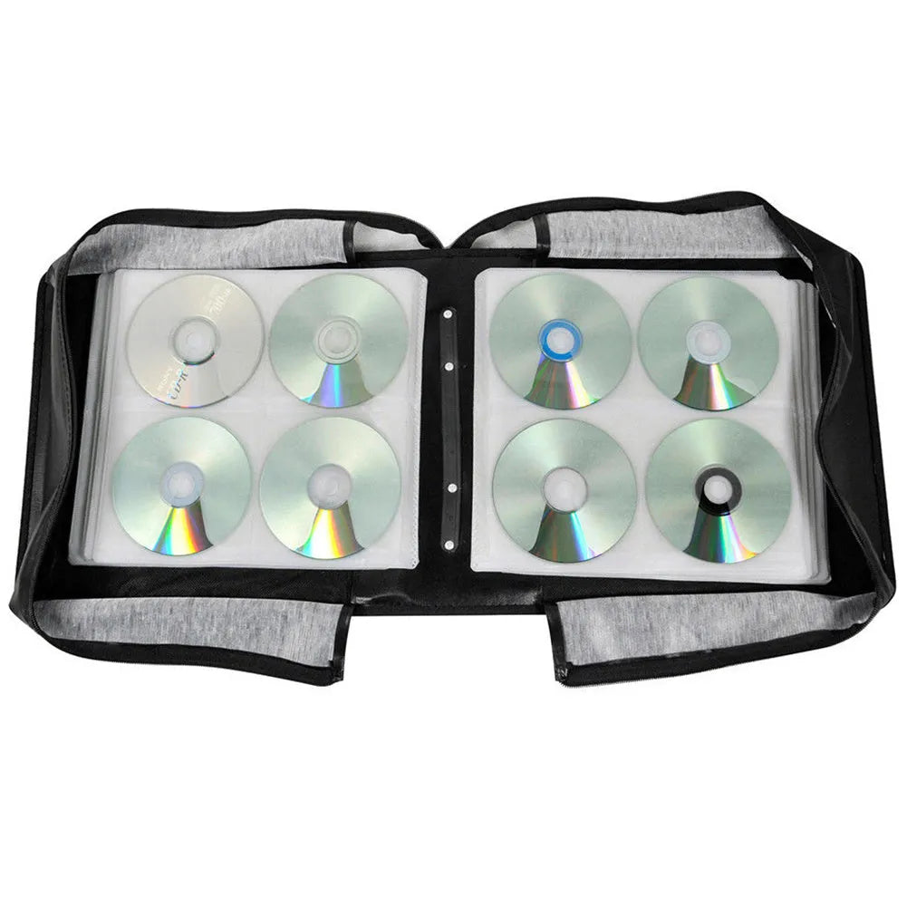 Black Oxford fabric CD storage binder with hand strap and zipper, holding multiple discs.
