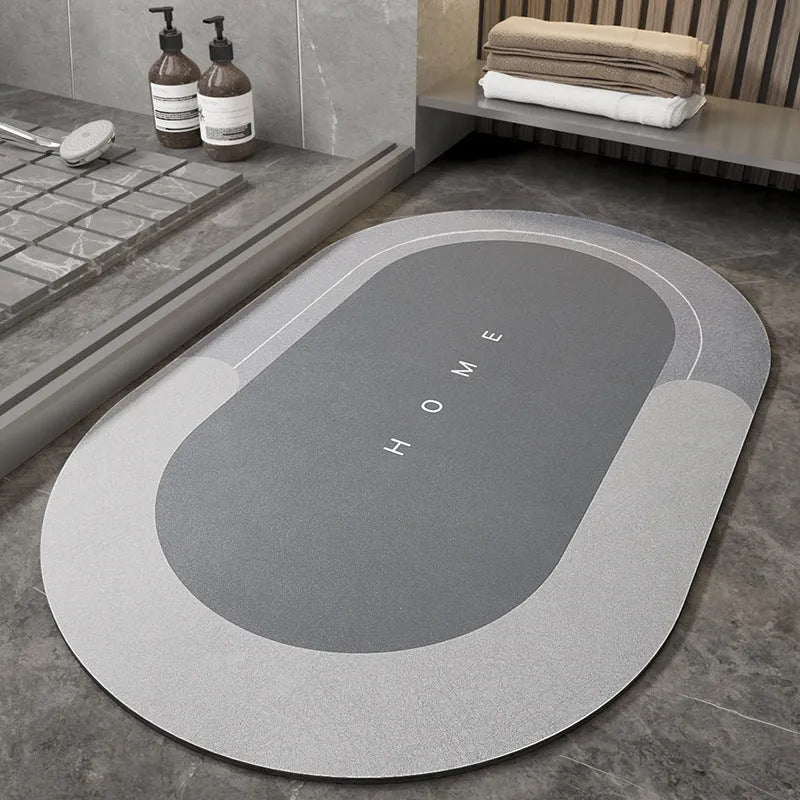 Soft blue oval bathroom floor mat placed on tiles beside a bathtub.
