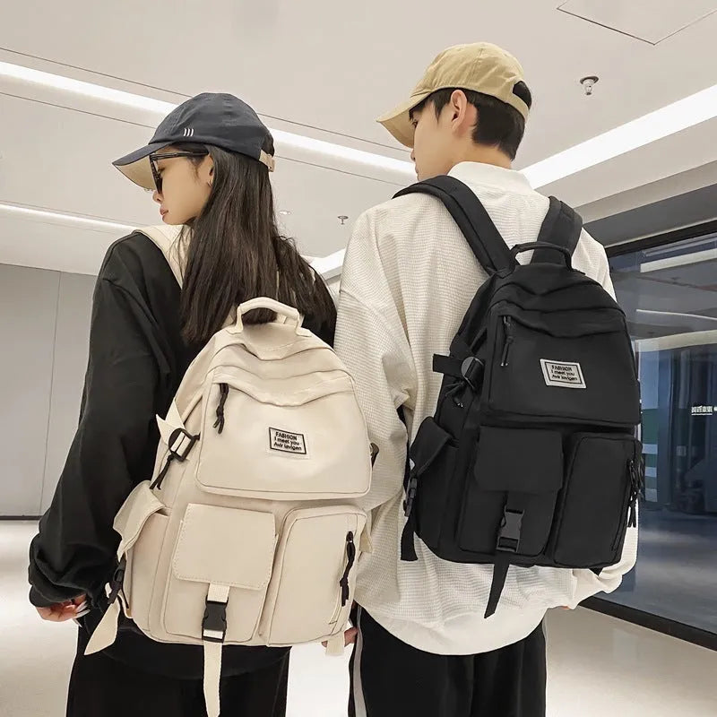 Soft nylon student backpack in black or white with computer compartment and three-dimensional pockets