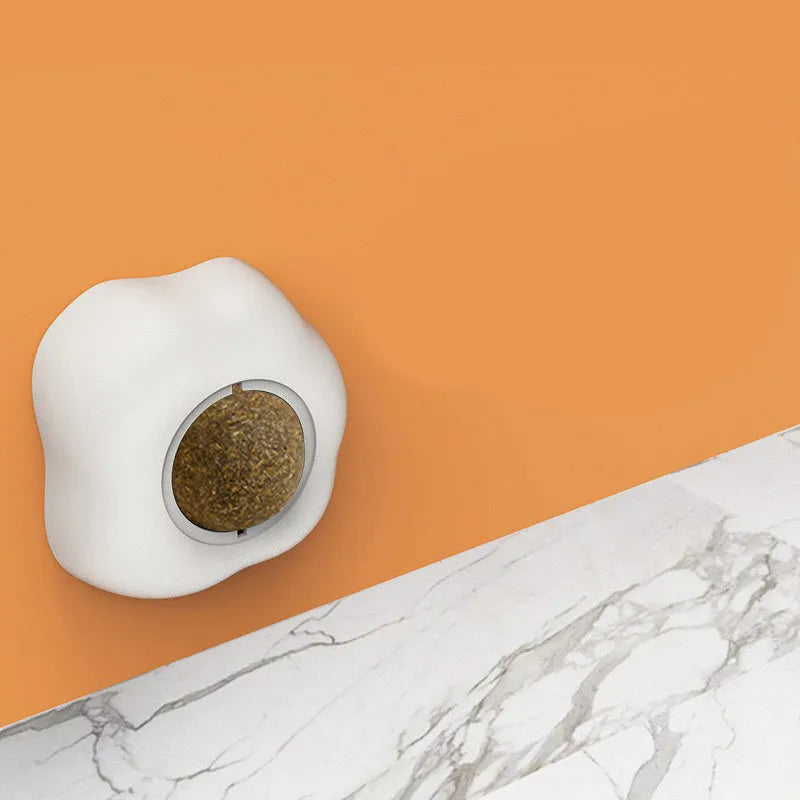 Soft plush catnip ball toy with suction cup mounted on a wall, shown in fried egg and poached egg shapes.