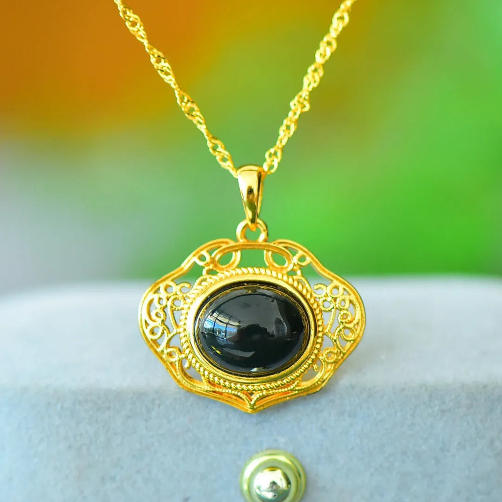 Flat copper inlaid pendant with natural ink blue Hetian jade stone on a necklace.
