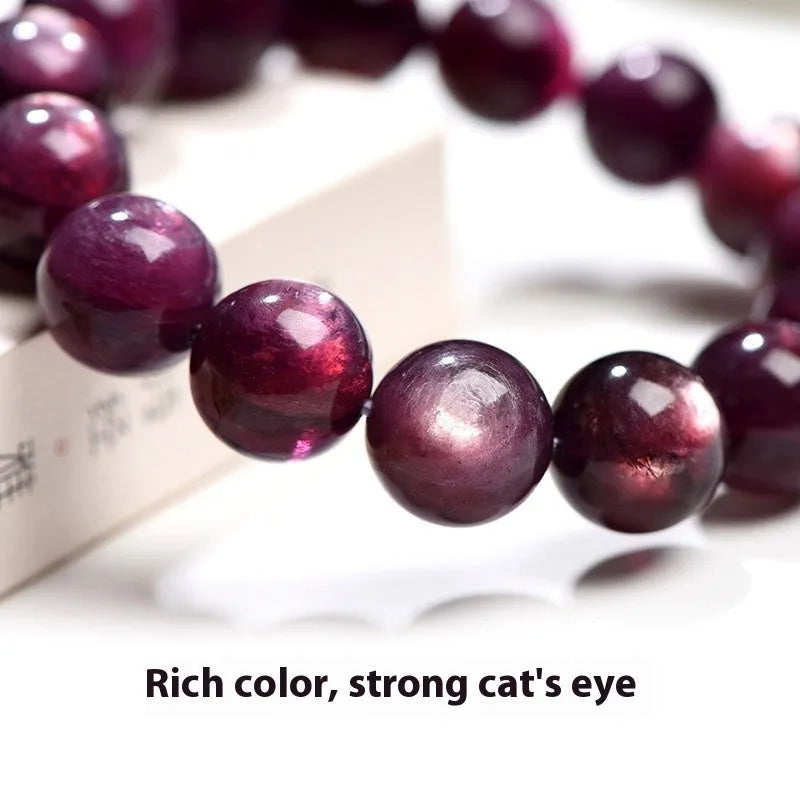 Natural purple lepidolite round bead crystal bracelet showing polished beads on a wrist.