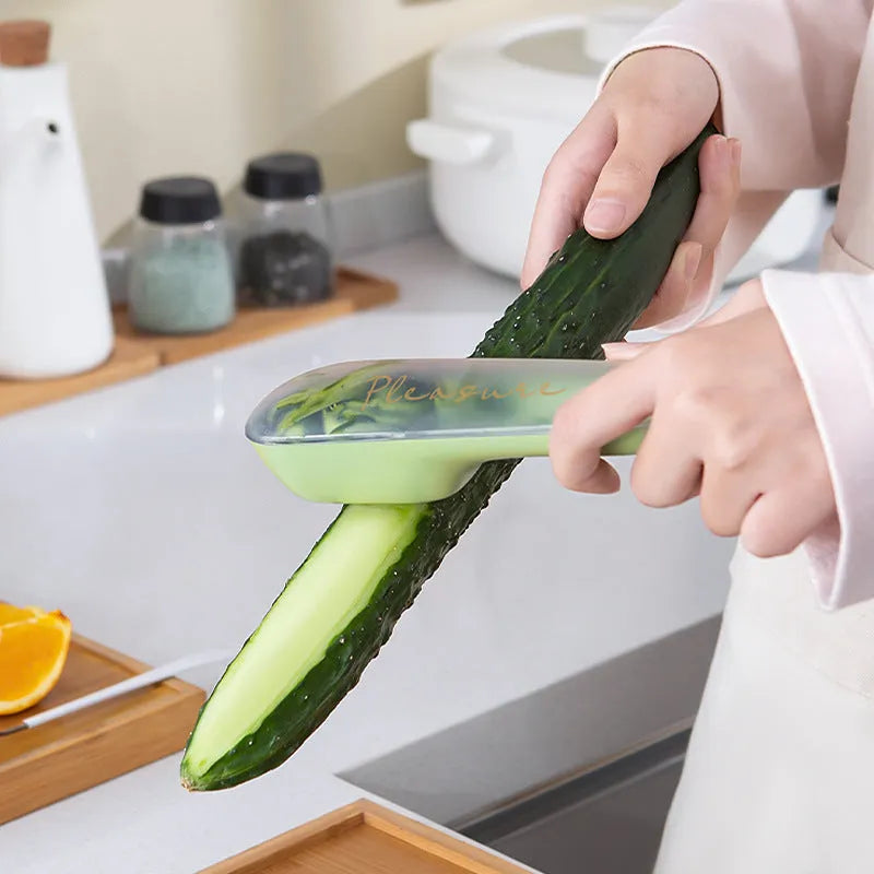 Dark green vegetable peeler with stainless steel blade and plastic storage tube
