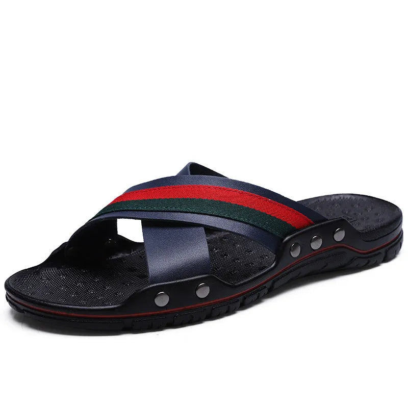 Men's cowhide leather flip-flop sandals with a non-slip PU sole in black, shown on a sandy beach.