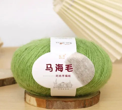 DIY mohair scarf weaving kit showing one wool ball and a selection of 34 colour options including white, pink, blue and green.