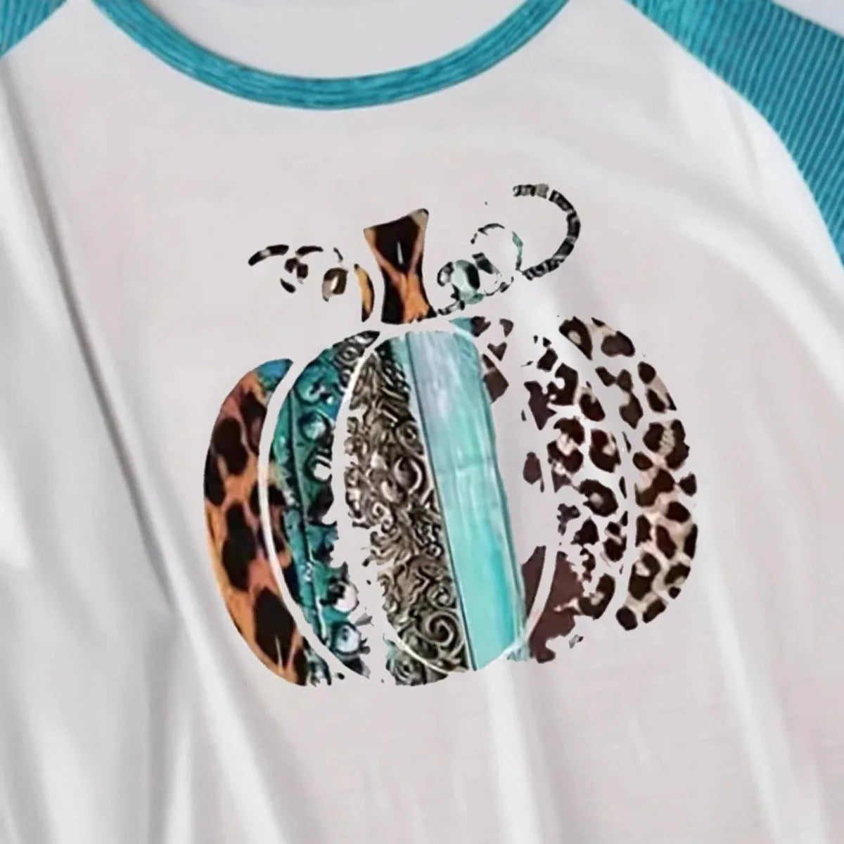 Sky blue Halloween t-shirt featuring a large white 3D digitally printed pumpkin design on the front.