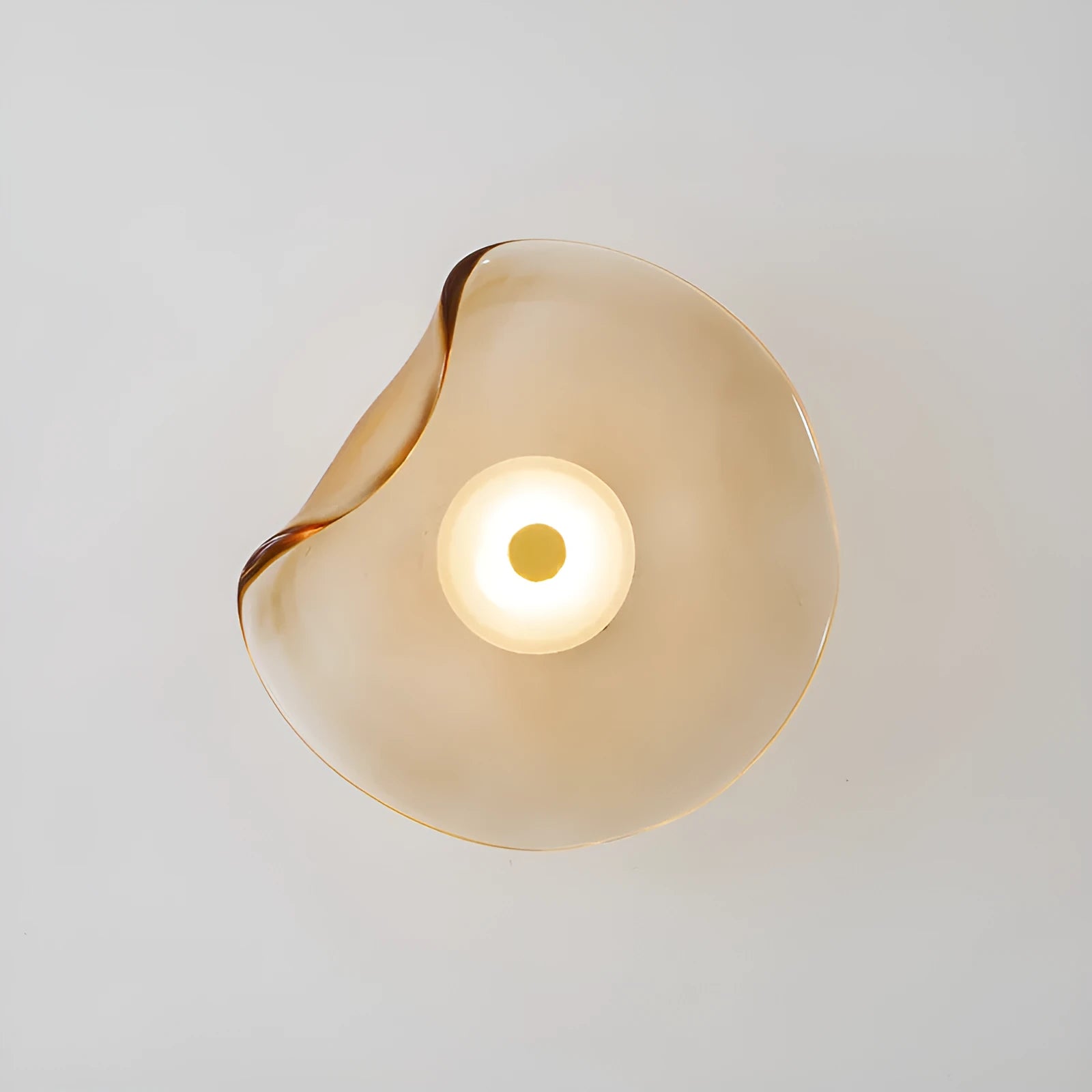 Round glass wall lamp in cognac colour with diffused lighting for bedroom bedside decoration
