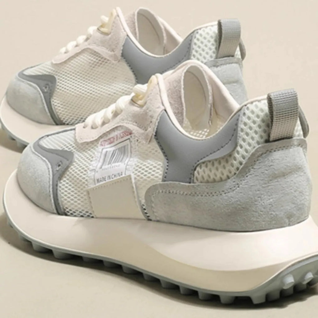 Women's grey and pink retro sneakers with mesh lining, rubber sole, and round toe design