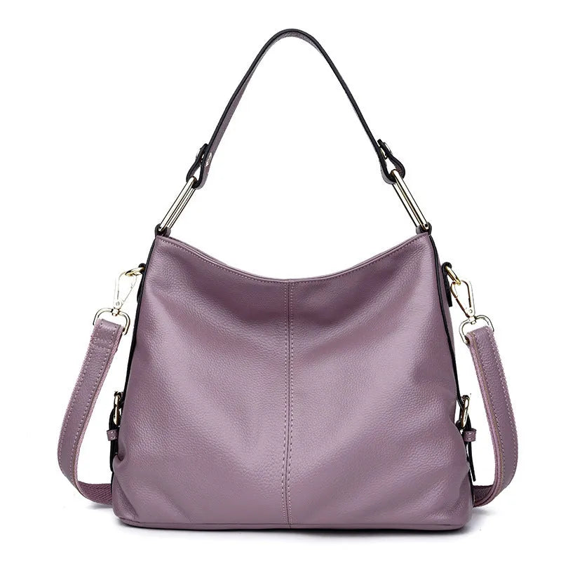 Square vertical genuine leather crossbody bag with multiple internal zipper compartments.