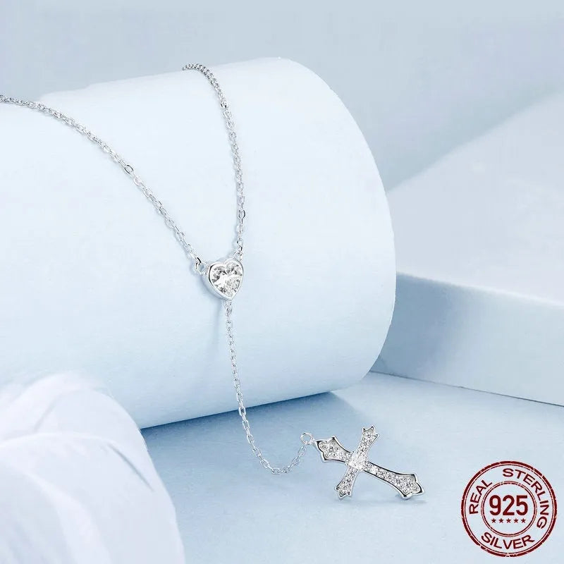 Simple sterling silver V-neck cross pendant necklace on an O-ring chain, colour BSN384.