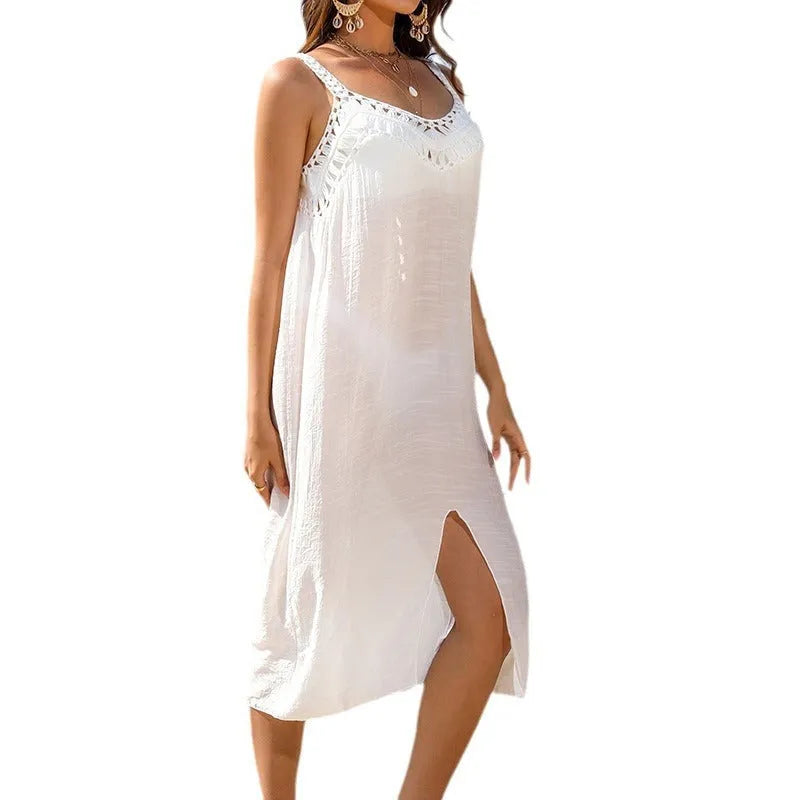 White suspender-style beach dress with hollow crochet weaving pattern and a bottom slit.