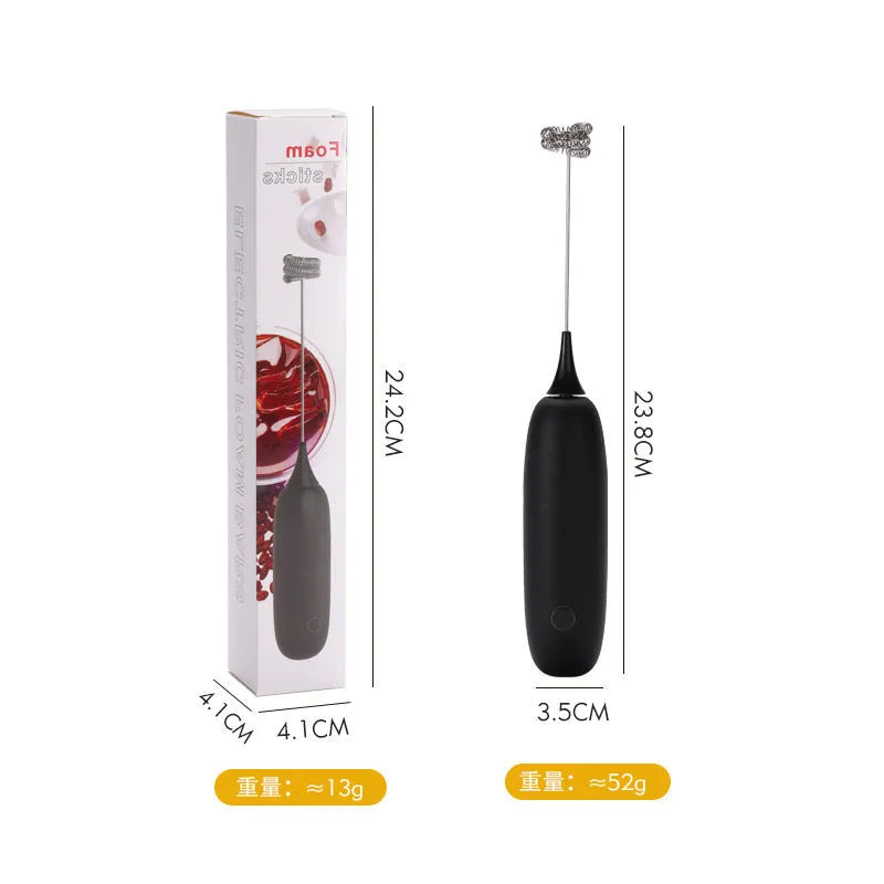 Black and white electric hand-held milk frother for coffee drinks