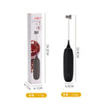 Black and white electric hand-held milk frother for coffee drinks