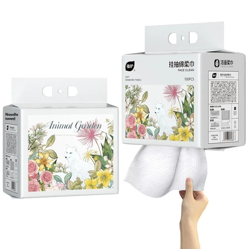 Roll of 100 disposable white face cloths on a hanging dispenser.