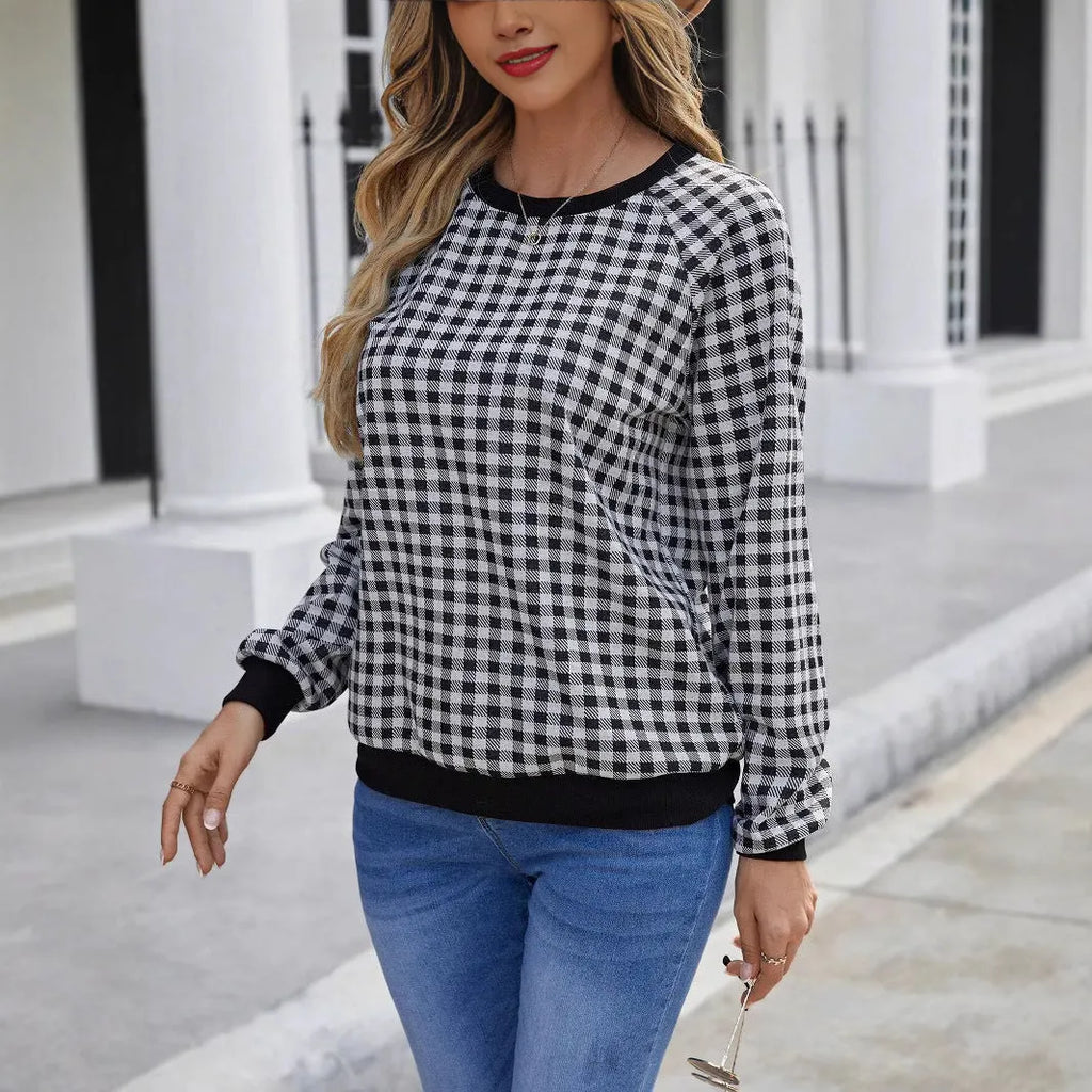 Black long sleeve pullover sweater with printed plaid and stripe pattern on a mannequin