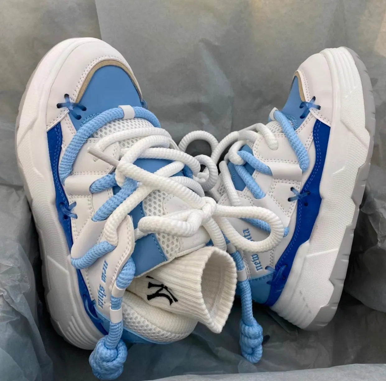 Women's grey retro platform sneakers with thick rubber sole and front lace-up closure