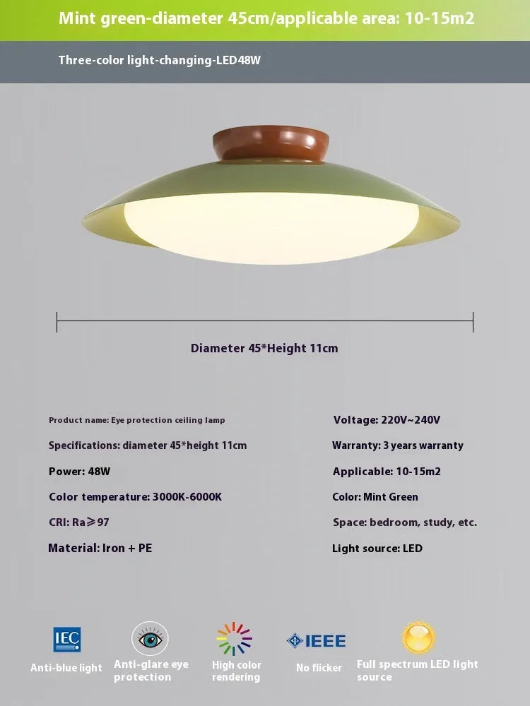 Modern flying saucer shaped ceiling lamp with an iron shade, shown in a cream yellow finish.