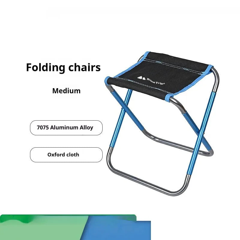 Black aluminium alloy folding stool in collapsed position for camping and outdoor use