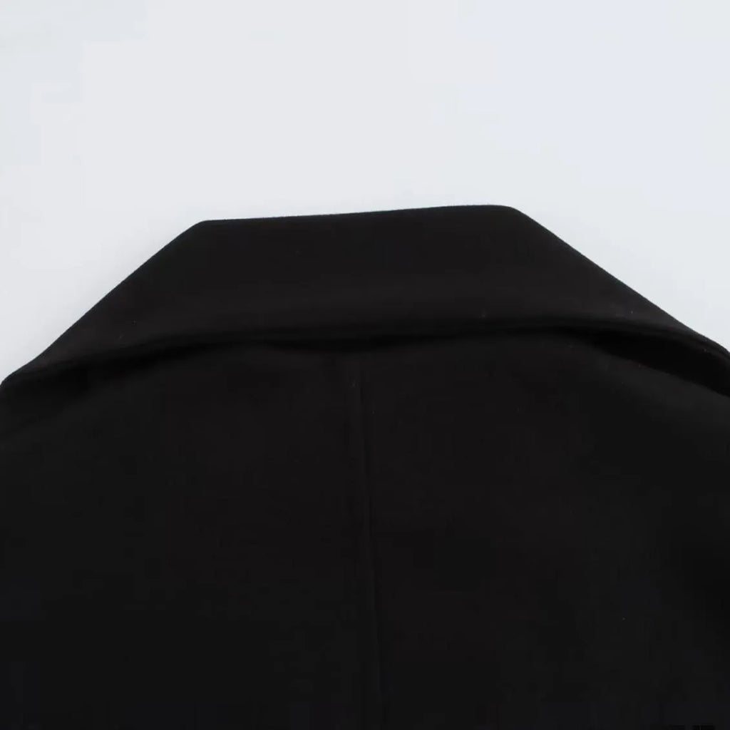Women's long grey wool blend overcoat with a large artificial fur collar and pockets.