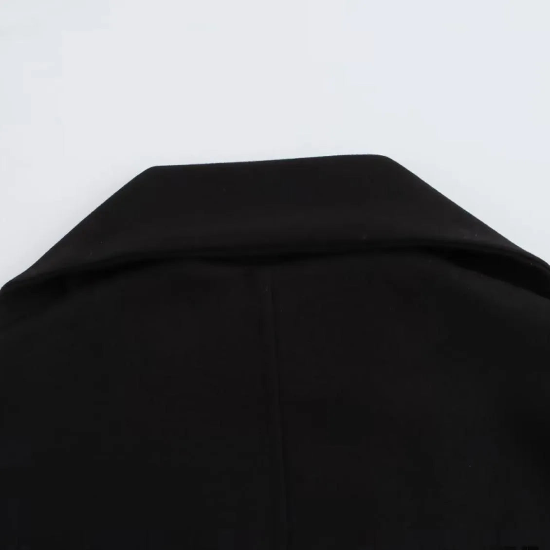 Women's long grey wool blend overcoat with a large artificial fur collar and pockets.