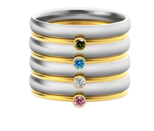 Geometric December birthstone engraved ring in titanium steel on a plain background.