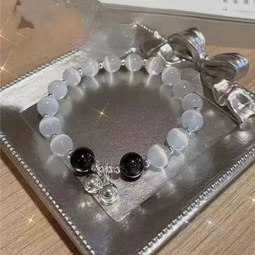Handmade glass butterfly charm bracelet for women in a drop shape with round details.