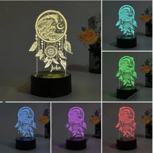 Black base dream catcher night light with colourful acrylic shade and remote control on a bedside table